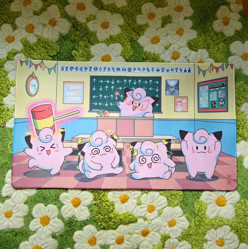 A photo of a yellow, blue, and pink classroom themed playmat laying on a green and white daisy carpet.